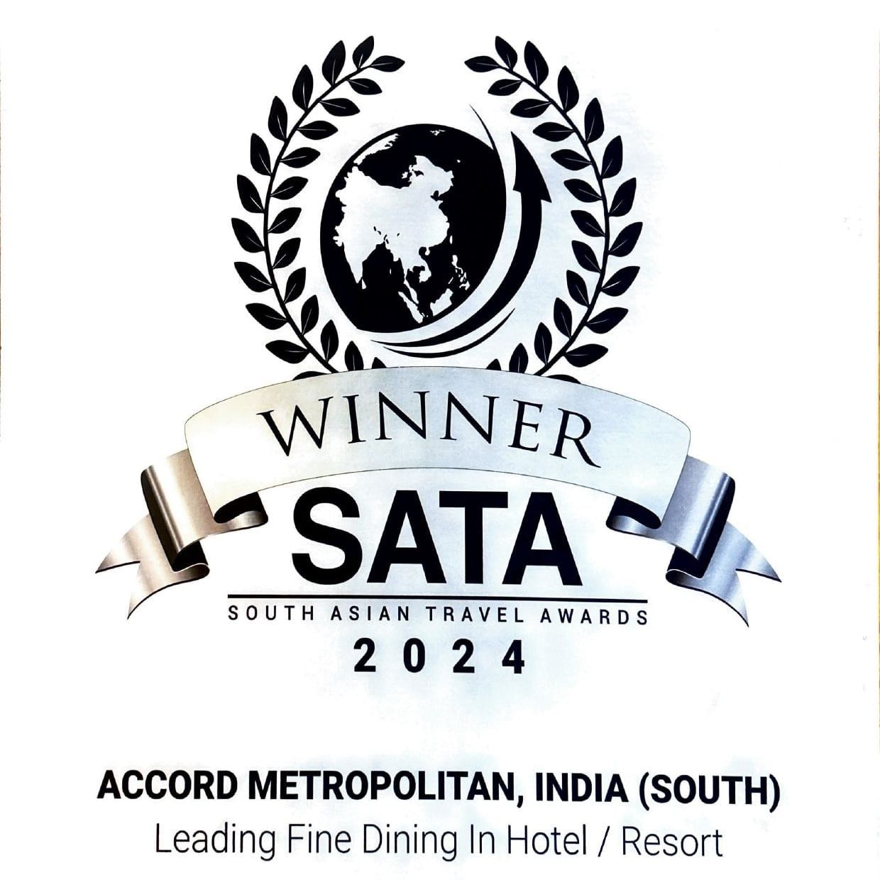 Winner badge for South Asian Travel Awards (SATA) 2024 with a globe and laurel design, awarded to Accord Metropolitan, India (South) for Leading Fine Dining in Hotel/Resort.