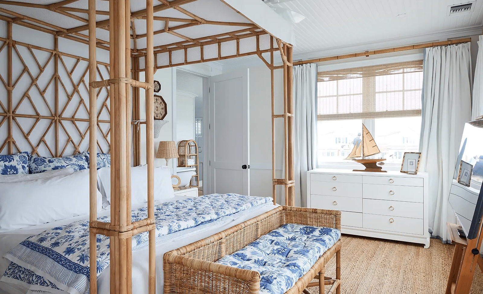 Bedroom with a canopy bed, nautical decor, and large windows | Abaco Inn