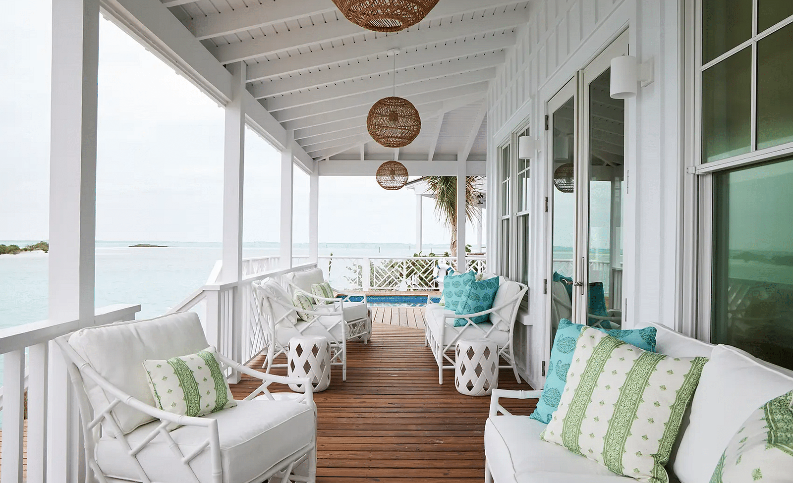 Porch with cushioned seating offering a view of the water | Abaco Inn