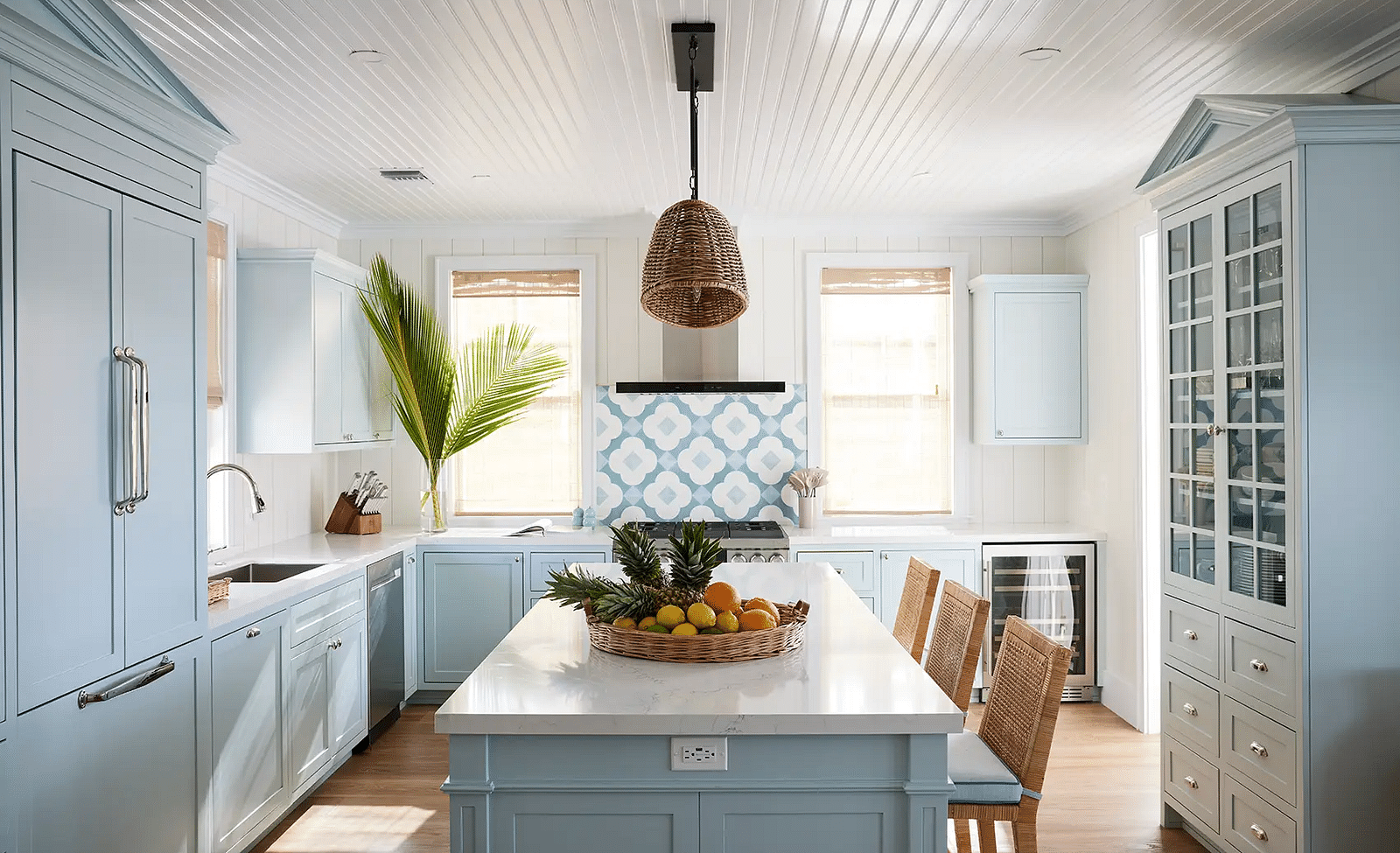 Kitchen with blue cabinetry, island seating, and modern appliances | Abaco Inn