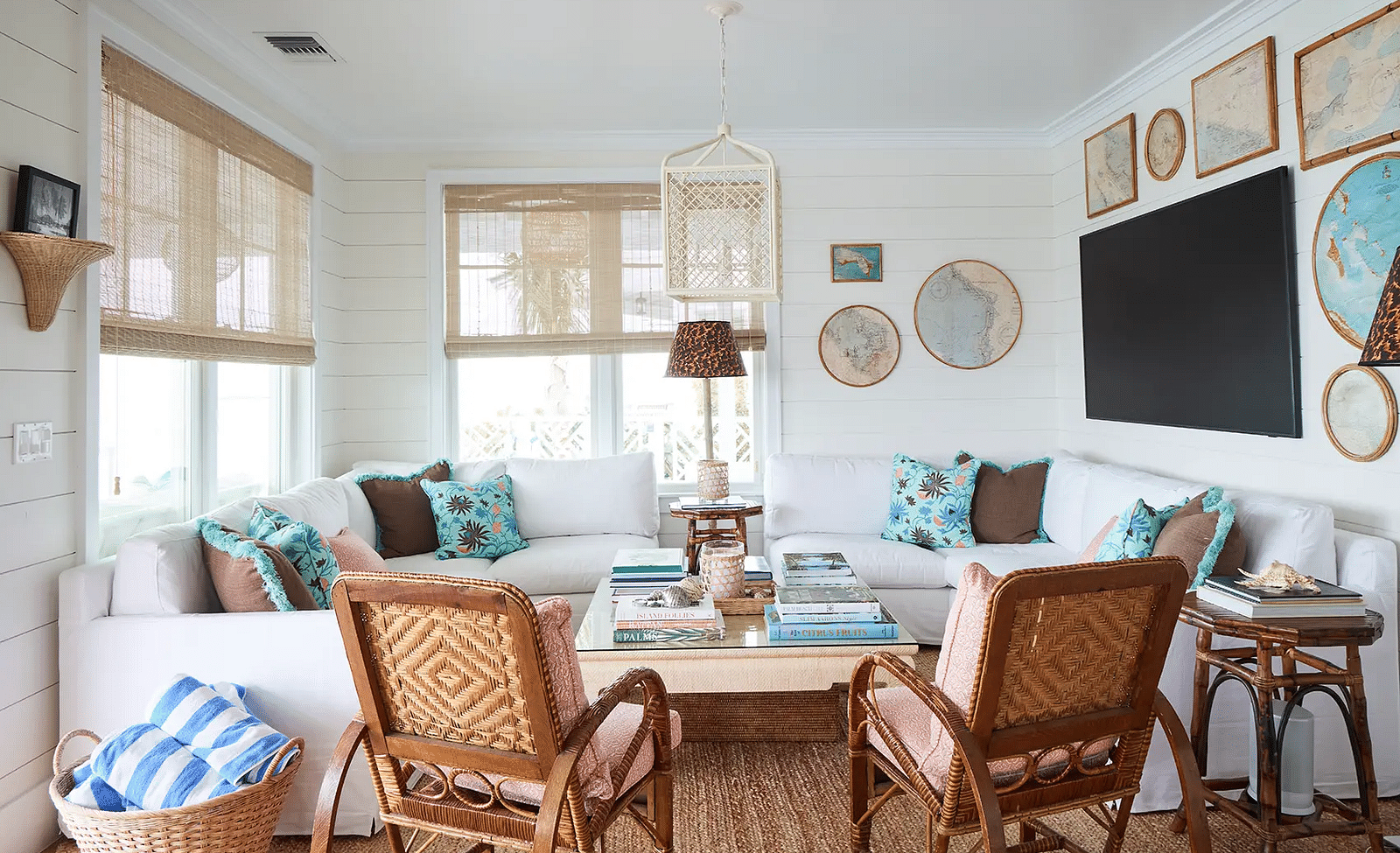 Living room with wicker chairs, coastal decor, and a large TV | Abaco Inn