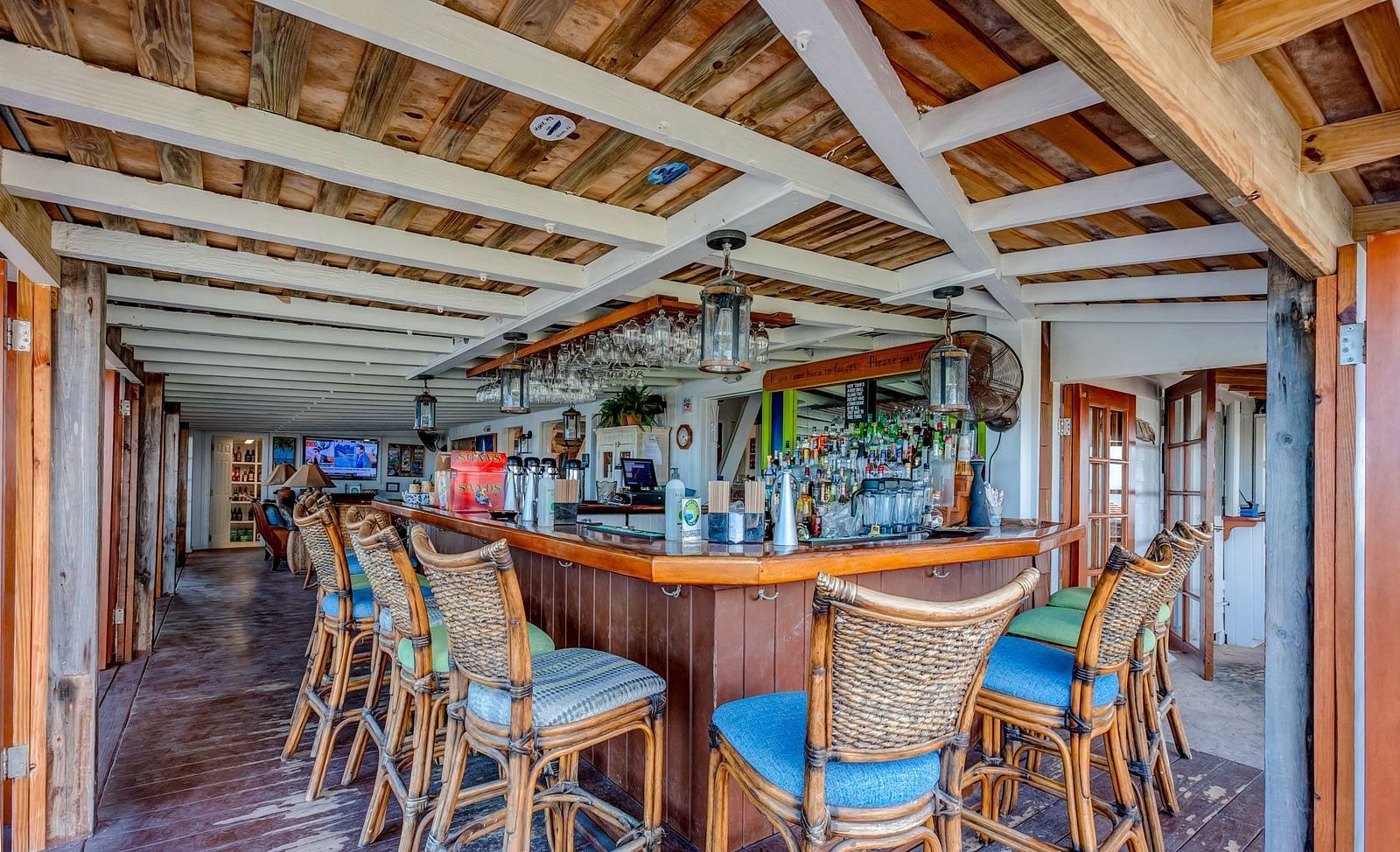Bar counter with high chairs and wooden ceiling inside the dining area | Abaco Inn