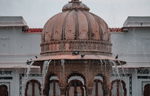  Dome structure with water feature, overcast sky.