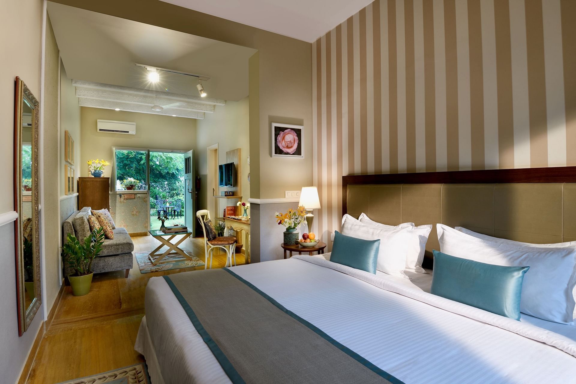 A room with a huge bed, lamps, and a window view at Karma Chalets.