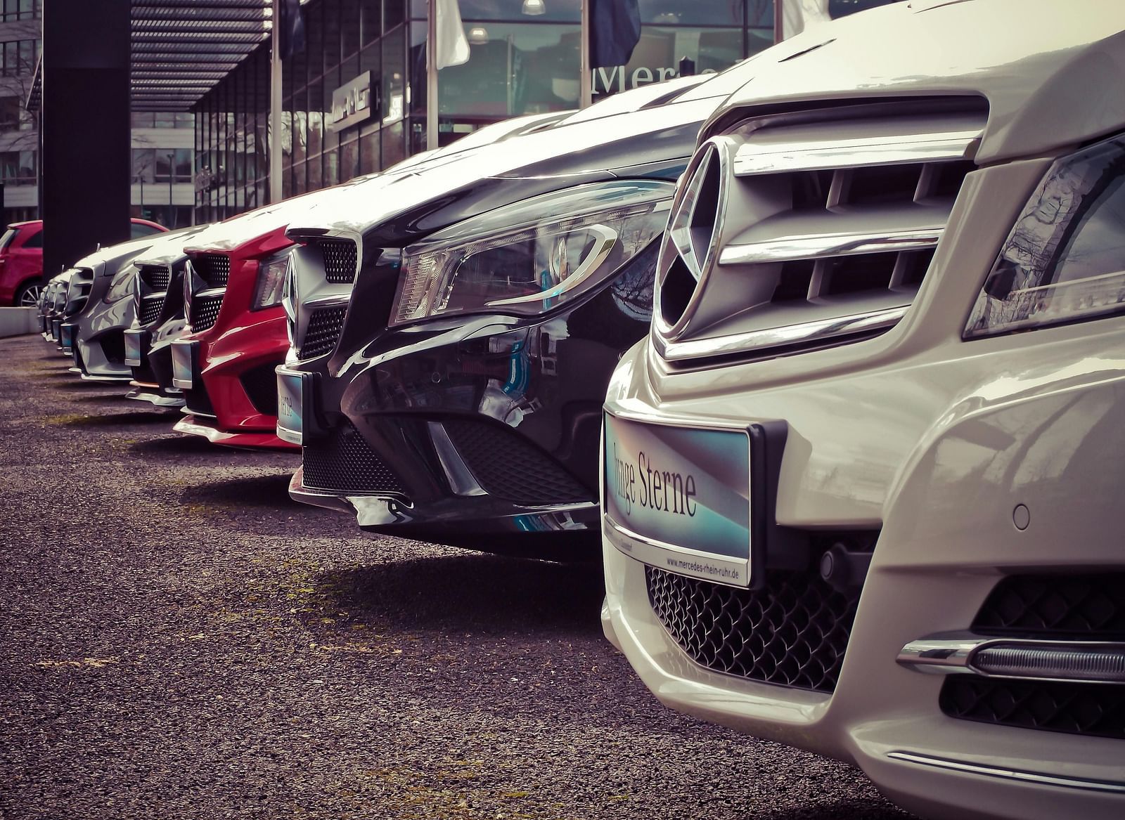 A row of parked cars with only the front visible.