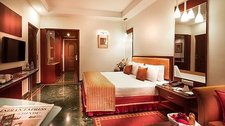 an image of a bedroom with stylish hanging lights from the ceiling at Regency Madurai by GRT Hotels