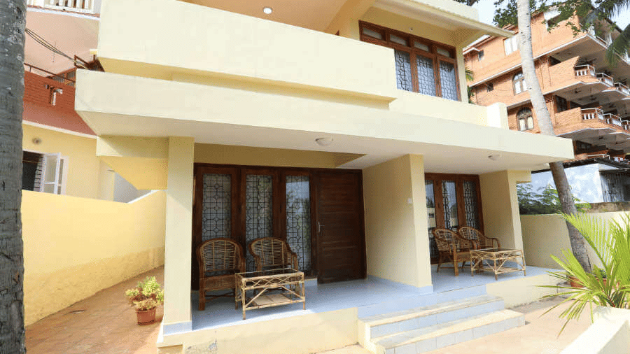 A building entrance of Abad Serviced with steps, seating, and an open porch area