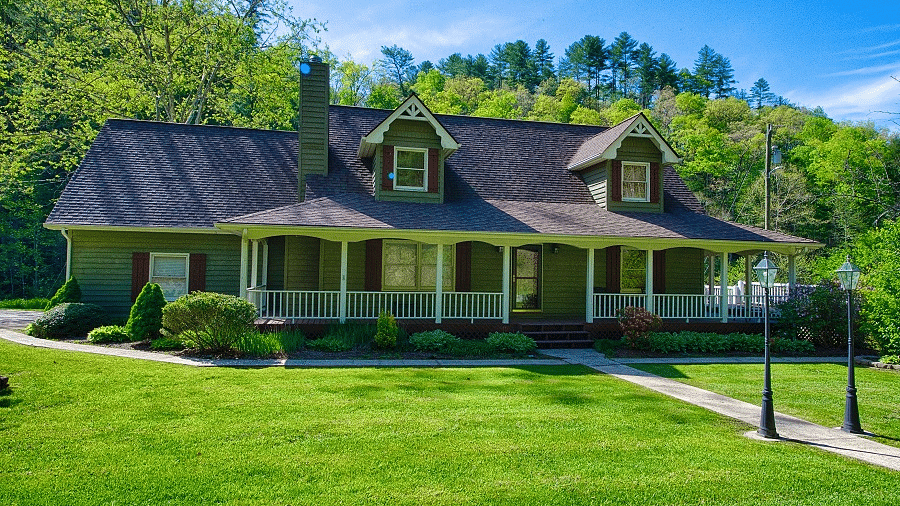 facade image of a villa with an expansive well pruned lawn in front of it - Historic Tapoco Lodge