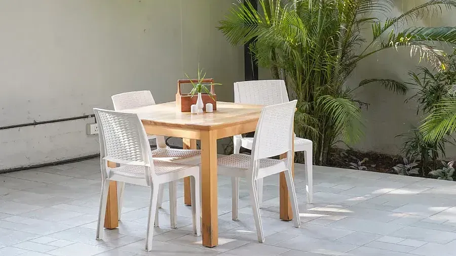 Dining setting with comfortable chairs around a table in Aqua Vida Restaurant at Indie Stays Resort, Goa.