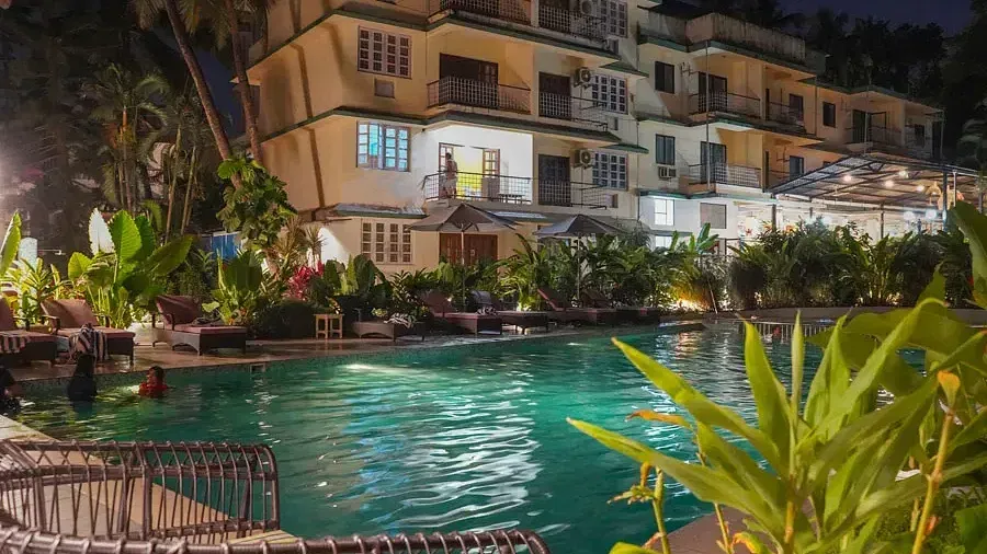 View of swimming pool at night at Indie Stays Resort, Goa.