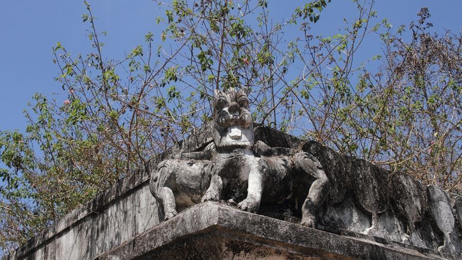 Stone sculpture of mythical creatures and trees.