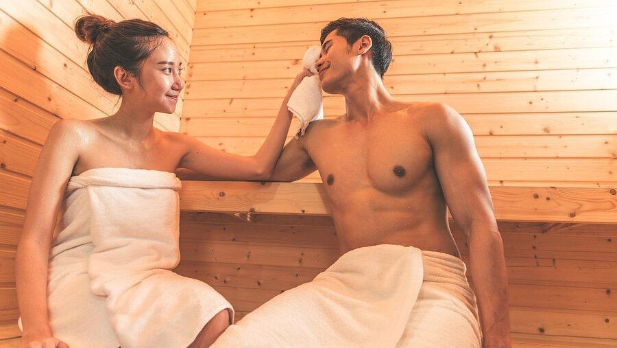 Playful moment between a couple in a sauna setting - Cedar Inn, Darjeeling