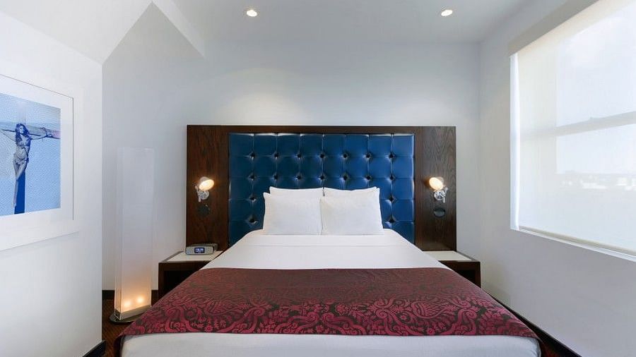 A large room with a bed and a window that overlooks the surroundings