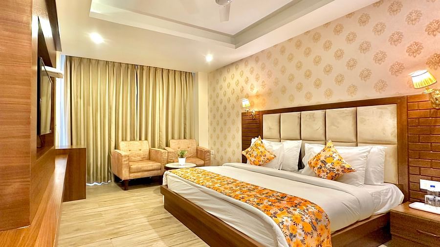 corner view image of the premium room with elegant interiors and warm lighting - ZENQ SIGNATURE INN, MCLEODGANJ