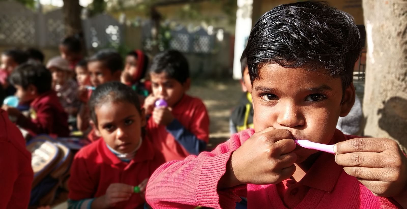 A boy trying to blow a balloon- Shahpura Bagh.