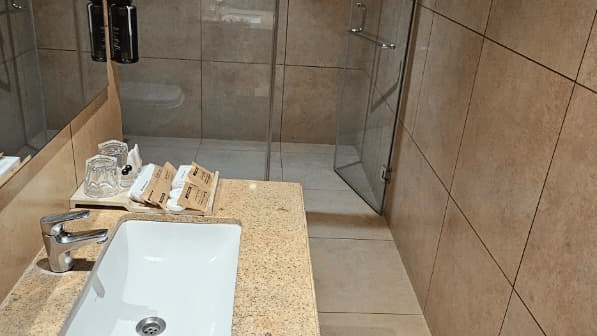 Bathroom counter with a recessed sink basin at Cholaa Dynasty, Kumbakonam.
