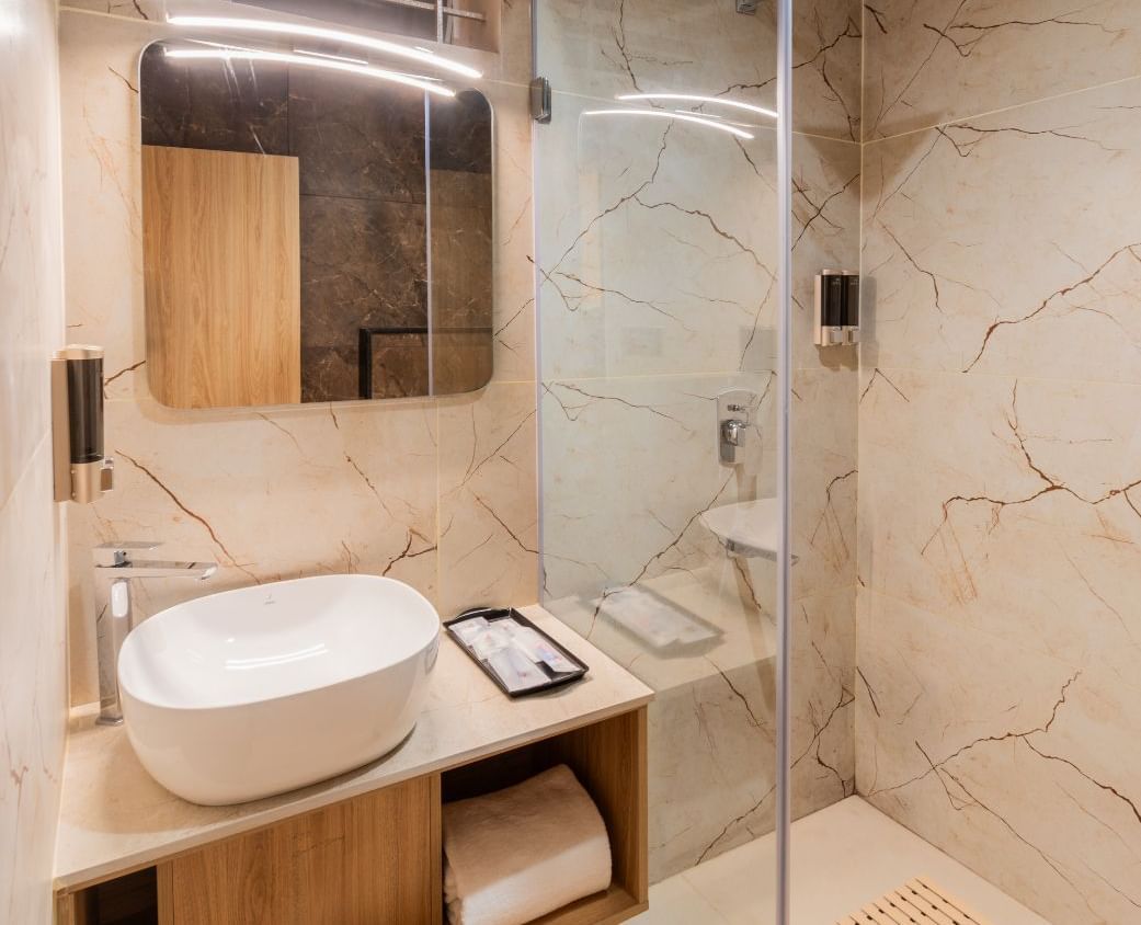 Washbasin and mirror in The Premium Rooms at TGI Livancia The Sojourn, Bangalore.