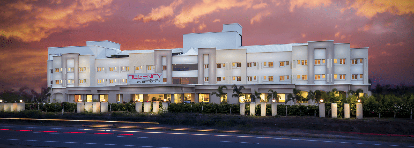 Facade image of Regency Tiruttani by GRT Hotels at dusk.