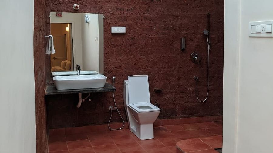  A spacious bathroom with a skylight, featuring a toilet and a sink at The Conservancy Bungalow.