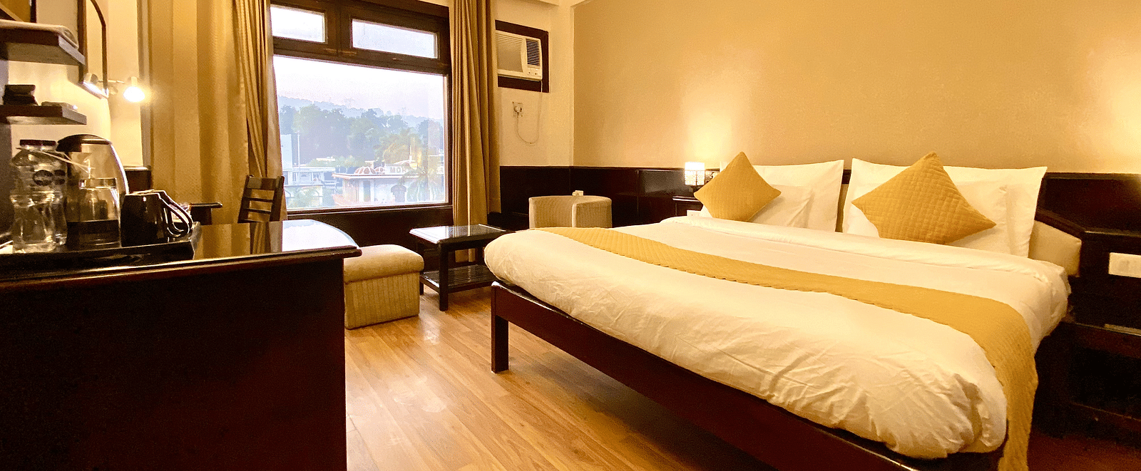 A room with a king size bed and multiple pillows at DLS Park Grace, Haridwar.