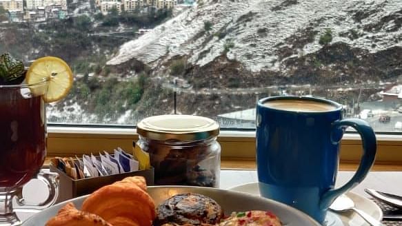 A delicious looking dish on a table with the expansive mountains overlooking it - The Orchid Hotel Shimla