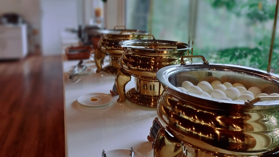 A buffet table chafing dishes in a restaurant setting  at Coorg Orange Blossom Resort & Spa