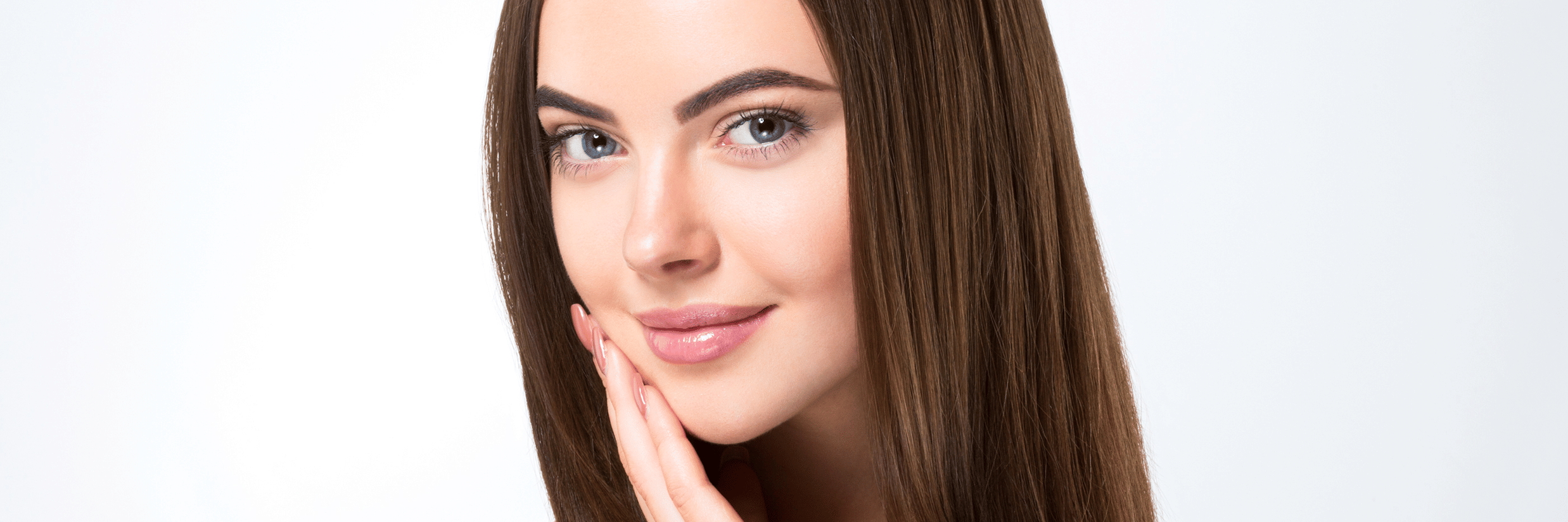 Glossy healthy hair of a woman displayed with a light backdrop.