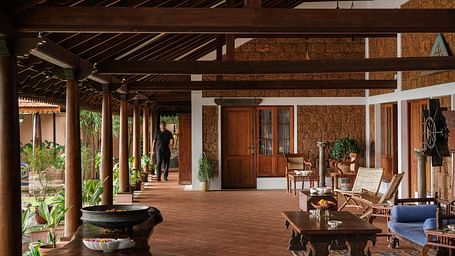 The outdoor seating area at BluSalzz Villas - Muhamma Resort, Alleppey with wooden chairs, sofa sets, coffee tables, and other wooden furnitures used for decoration