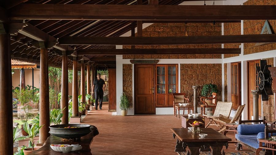 The outdoor seating area at BluSalzz Villas - Muhamma Resort, Alleppey with wooden chairs, sofa sets, coffee tables, and other wooden furnitures used for decoration