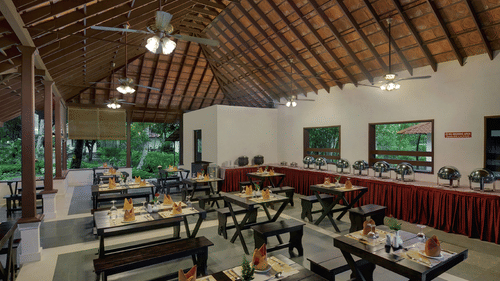 An open-air dining space in Abad Turtle Beach Resort, Marari Alleppey, an Alappuzha beach resort featuring high ceilings and buffet counter