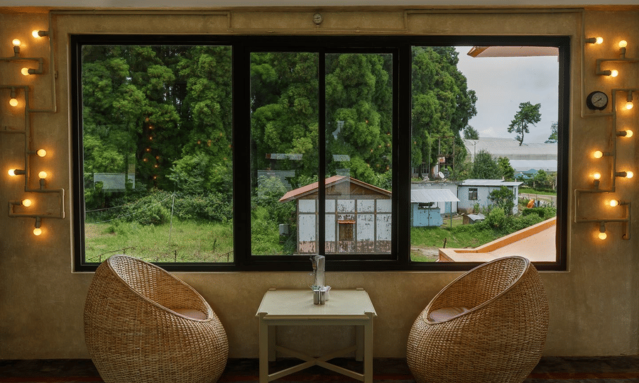 a seating area beside a window overlooking nature