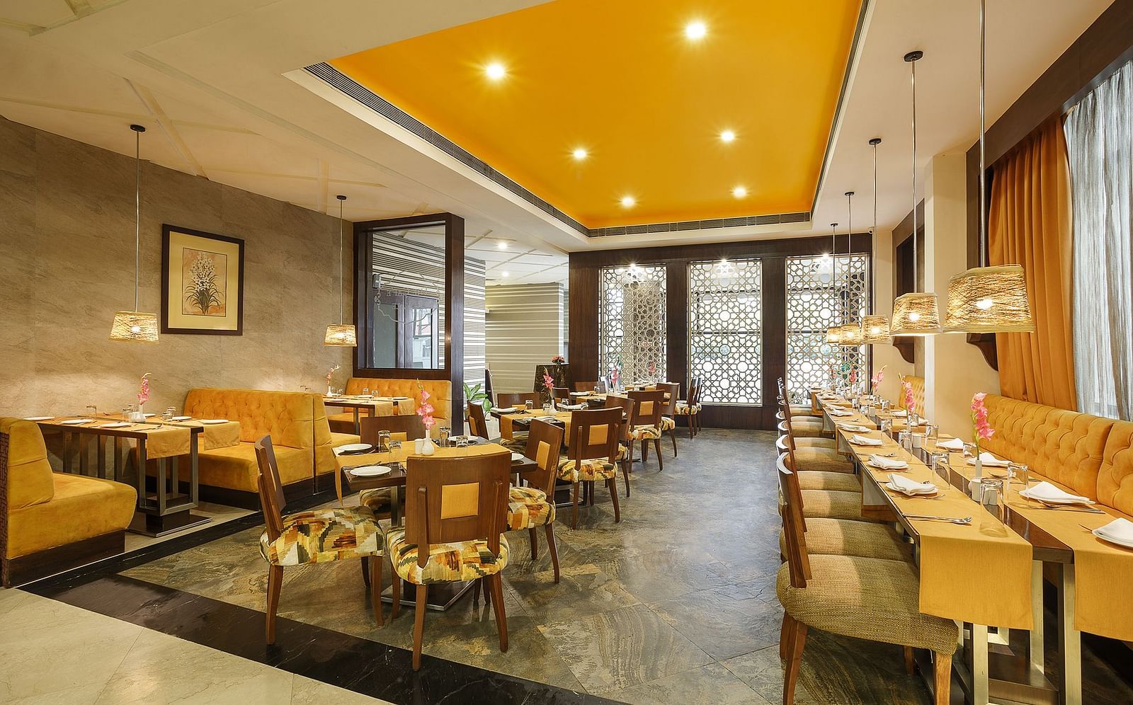 A spacious dining space with wooden chairs and a buffet setup ready to welcome guests for a meal - The Manor, Bareilly