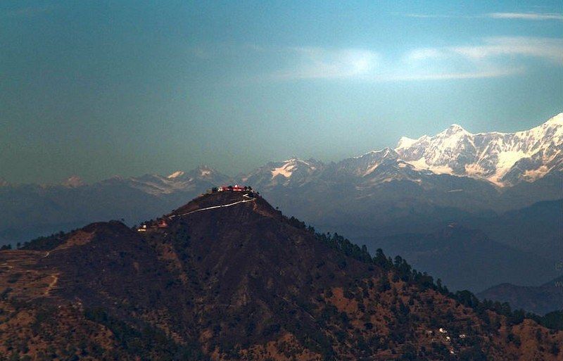 A long shot of a mountain, captured in a day light.