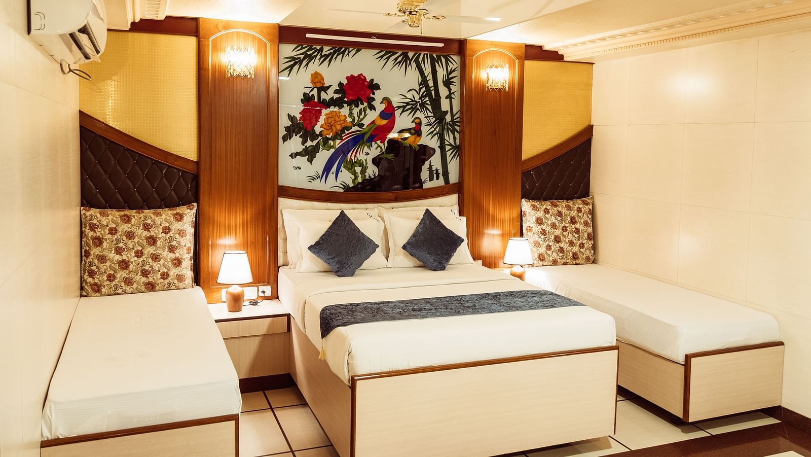 image featuring a double bed along with twin beds besides it at The Grand Krishna Rooms, Bengaluru
