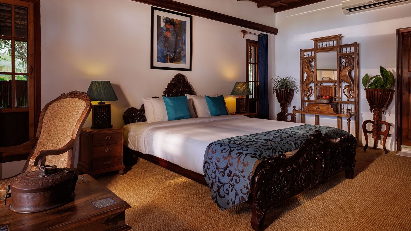 A room with a bed, a wooden dresser, a chair, and a coffee table - BluSalzz Villas - Muhamma Resort, Alleppey