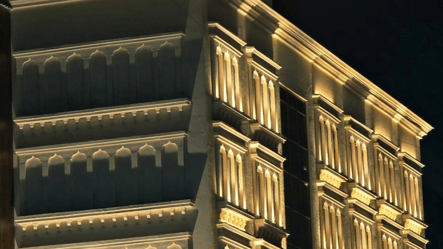 Night view of illuminated hotel building with signage at Hotel Mumbai House, Digha, Airoli.