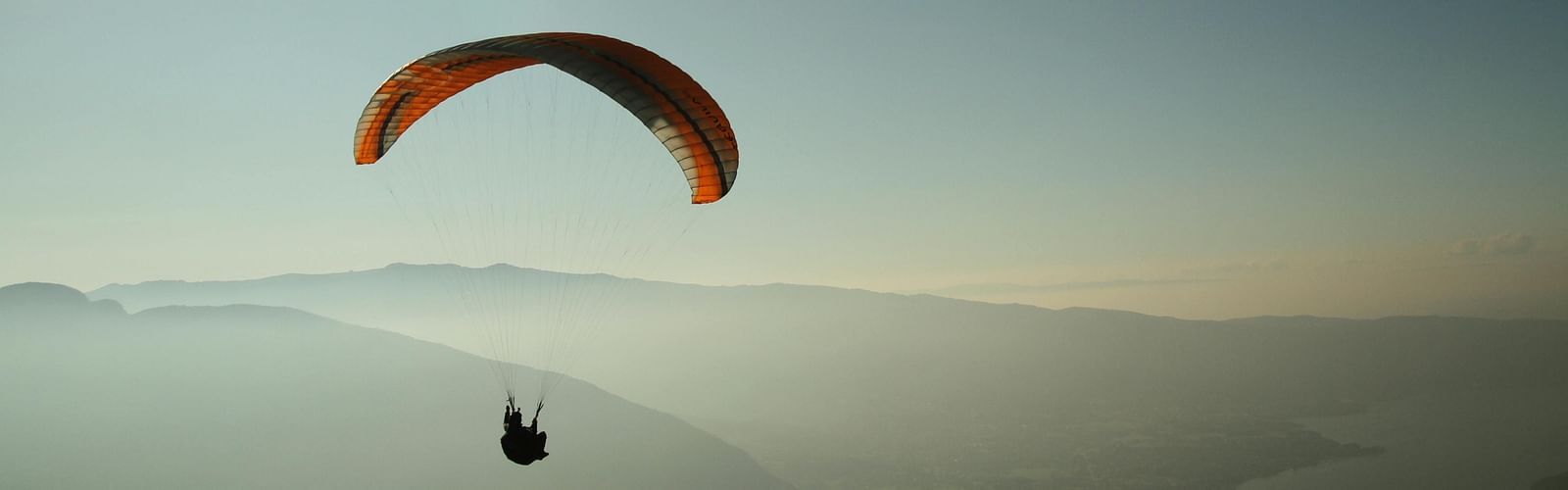 A person enjoying paragliding with a view of the mountains