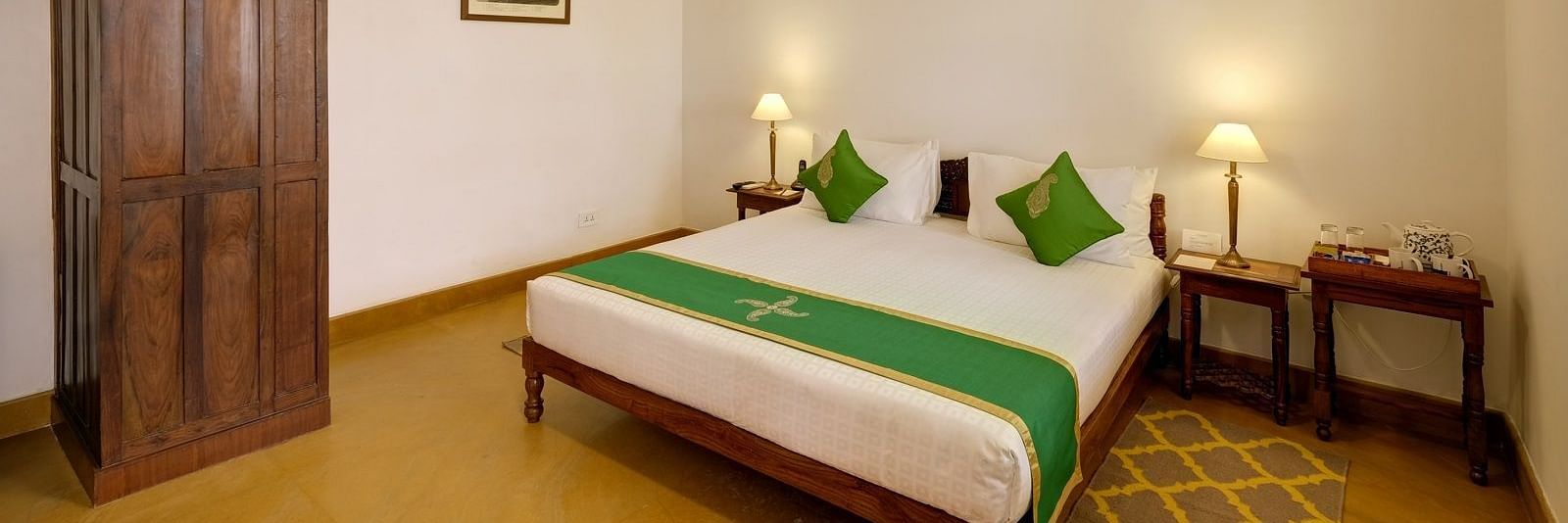 Residency Room with a double bed and a wardrobe at Saraca Hotel, Lucknow