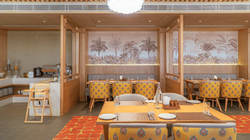 The restaurant at Pride Elite Himmatnagar boasts sleek wooden frames and an elegant dining atmosphere.