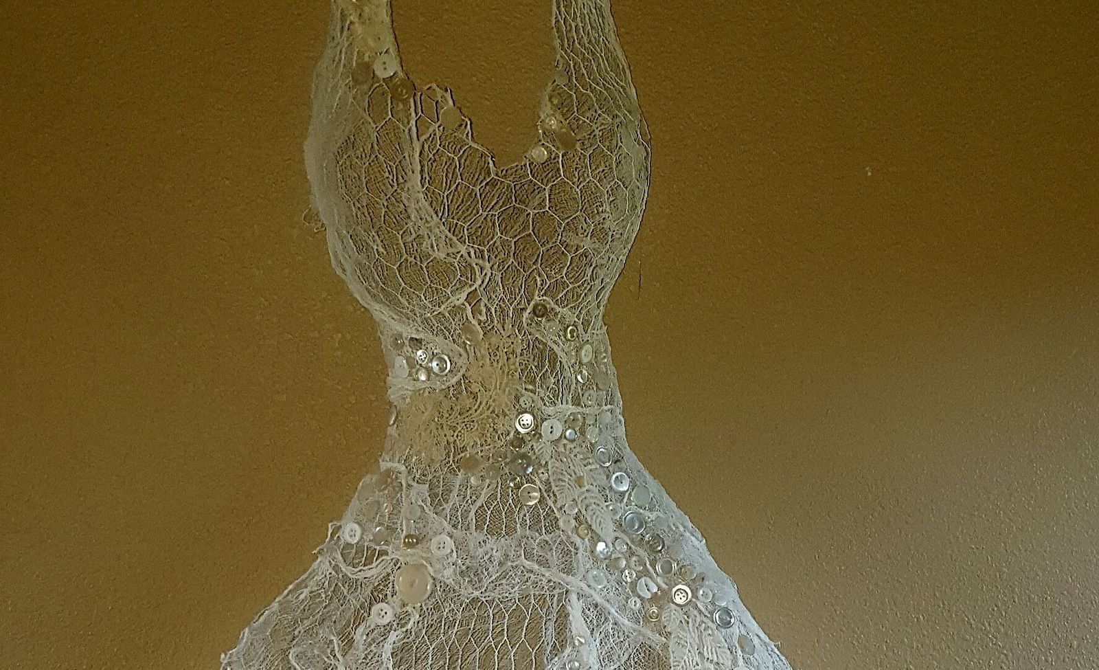 A delicate lace dress displayed as an artistic centrepiece - Brewery Gulch Inn & Spa