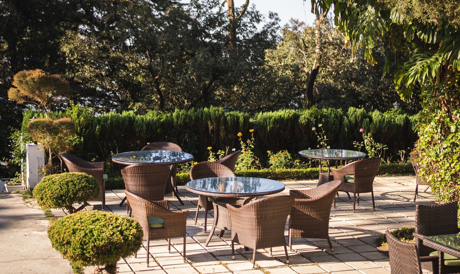 Outdoor Seating Area surrounded by plants at The Claridges Nabha Residence Mussoorie - Claridges Collection