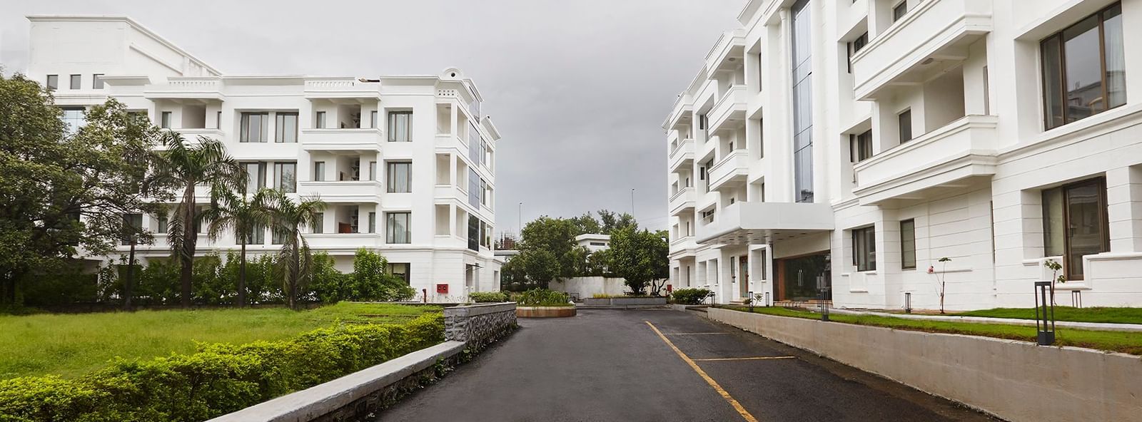 Another perspective of the clean, white-and-glass facade of Monday Hotels Mahape, Navi Mumbai.