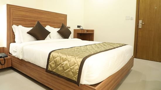 An image of a bed with bedding