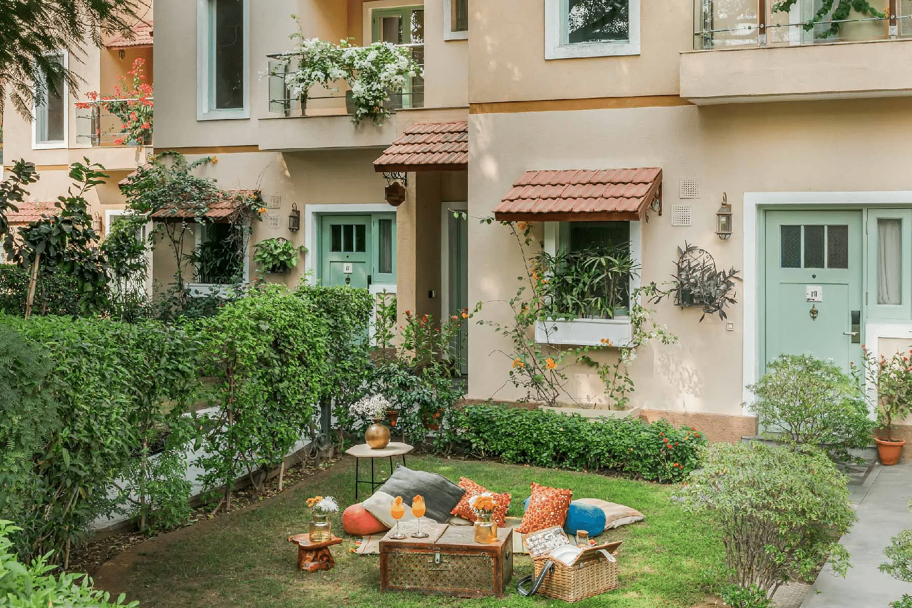 Exterior view of Karma Chalets building with balconies and lawn seating.