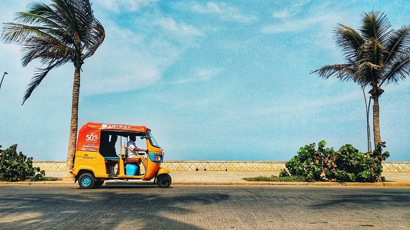 Man driving an auto against clear skies