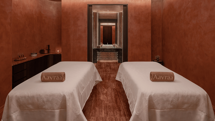 Spa treatment room with two massage beds set against warm toned walls at The Residency Signature Madurai.