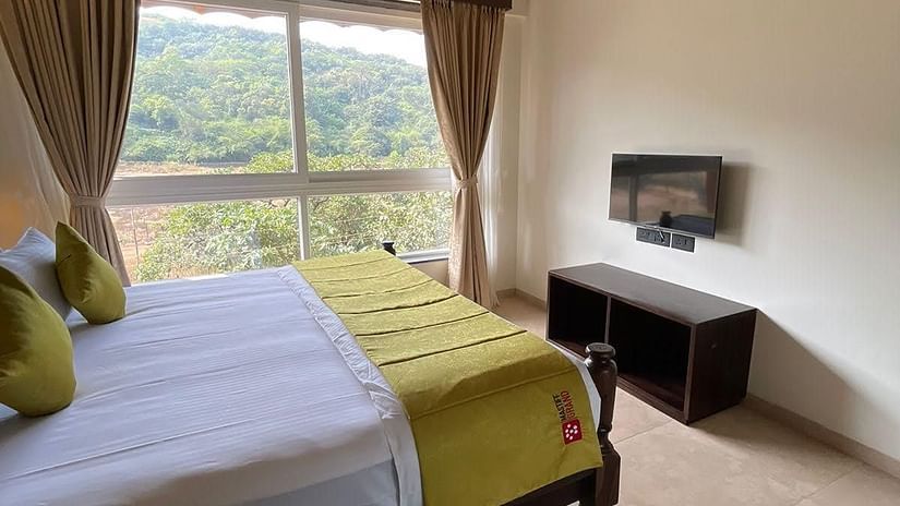 bedroom with forest view and bed