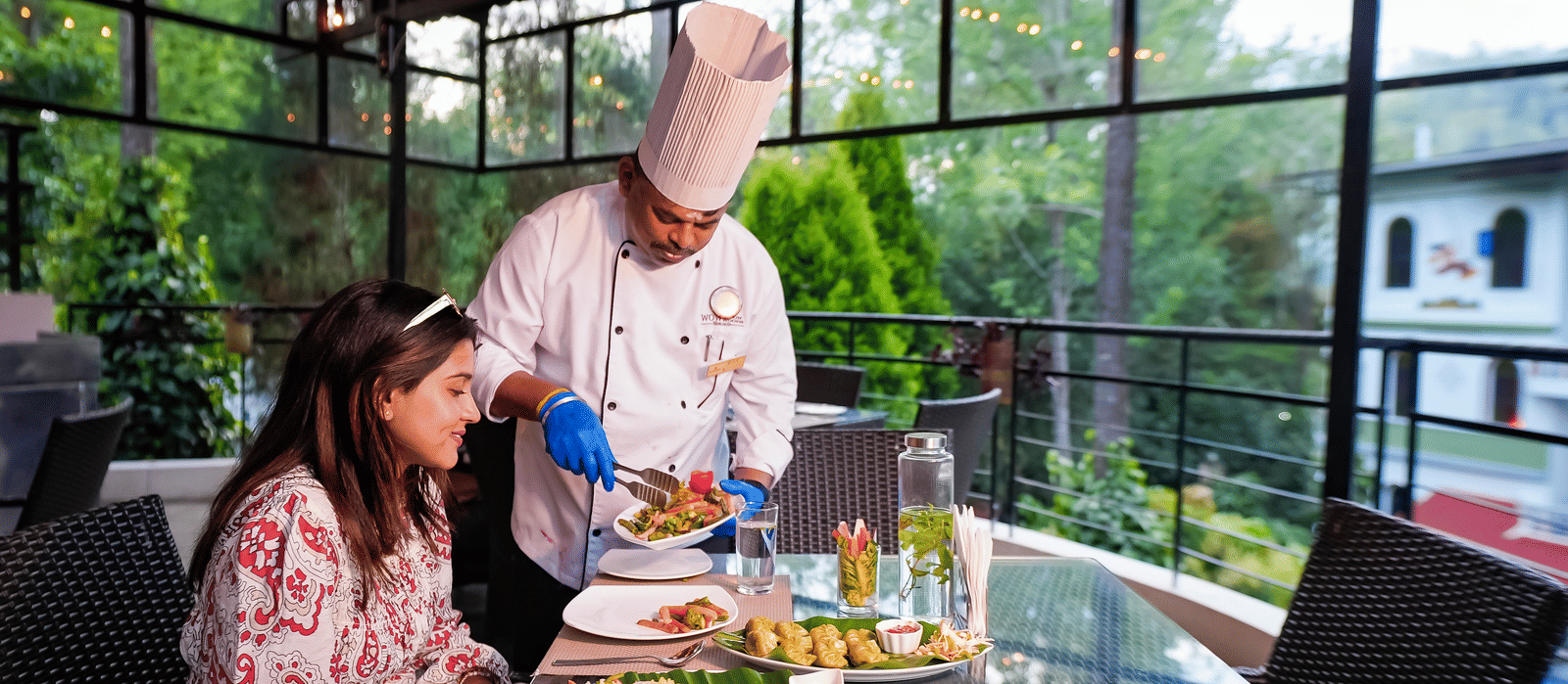 A chef serving food to a lady at WOW Bungalow, Yercaud.