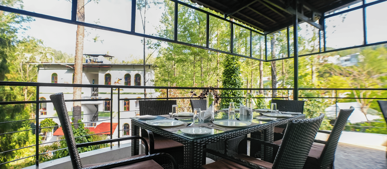 Close-up view of dining area with chairs arranged around the table at WOW Bungalow, Yercaud.