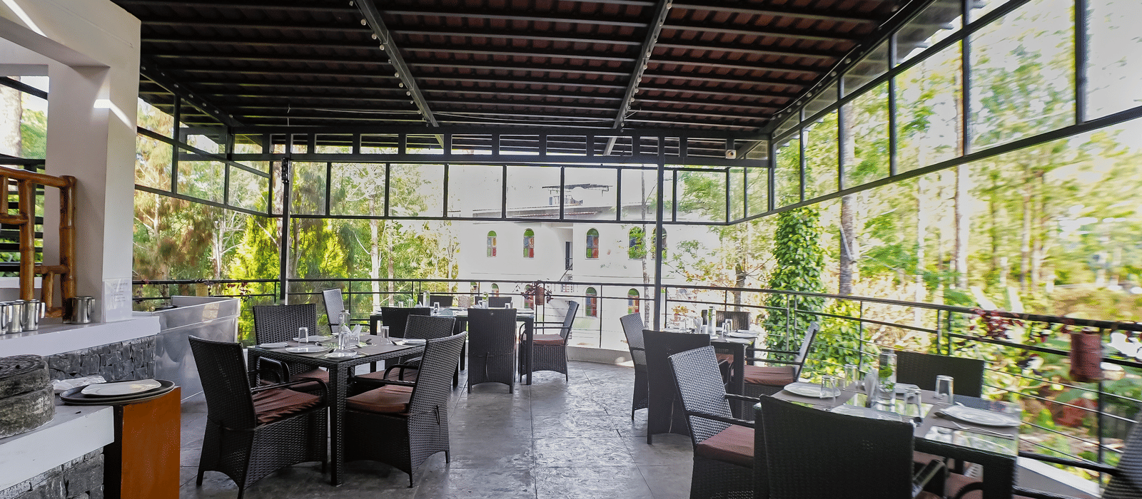 Full view of the dining area with table and chairs set at WOW Bungalow, Yercaud. 